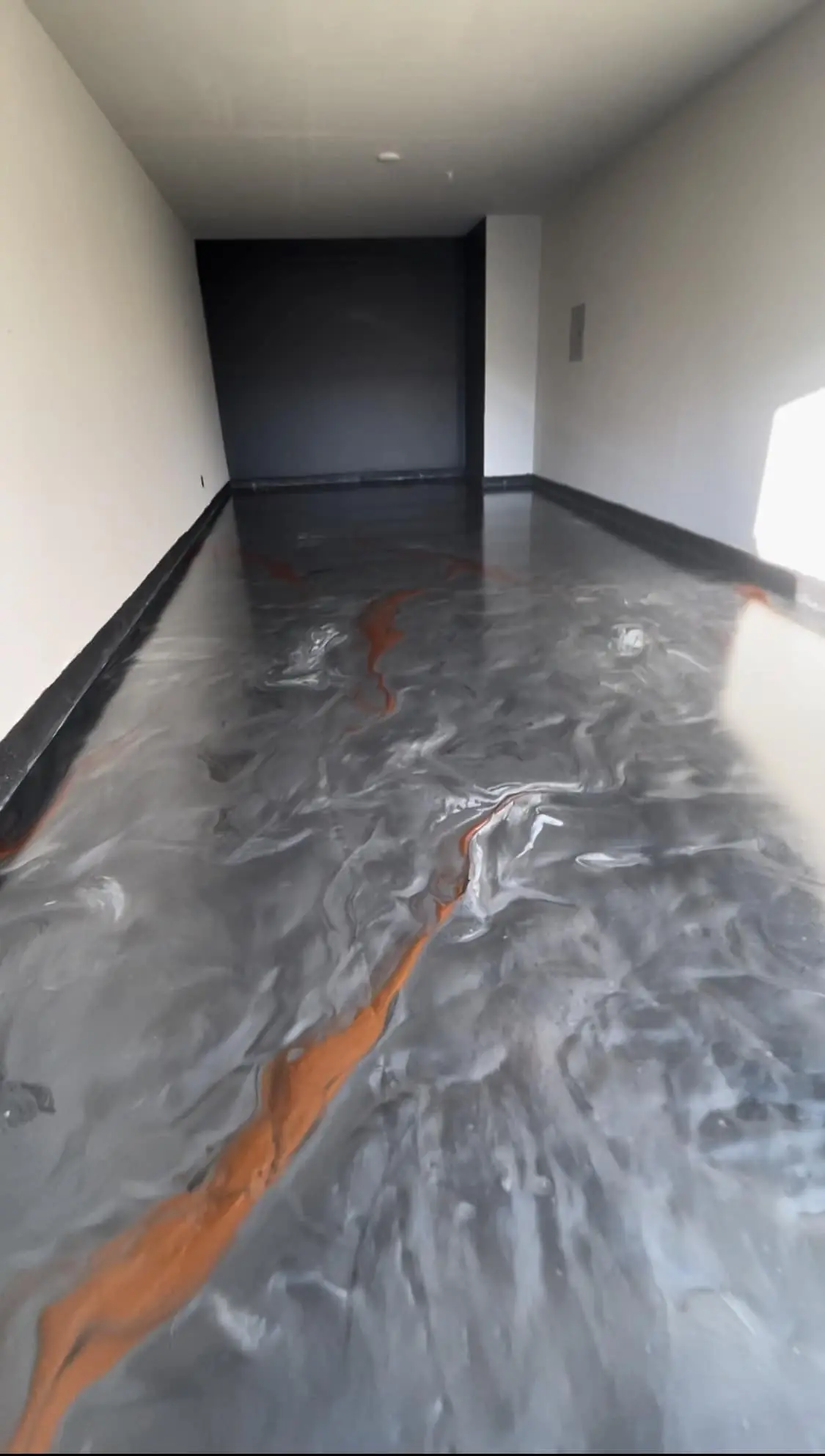 Gray flake epoxy floor in residential garage with metal railing, Denver Metro Colorado