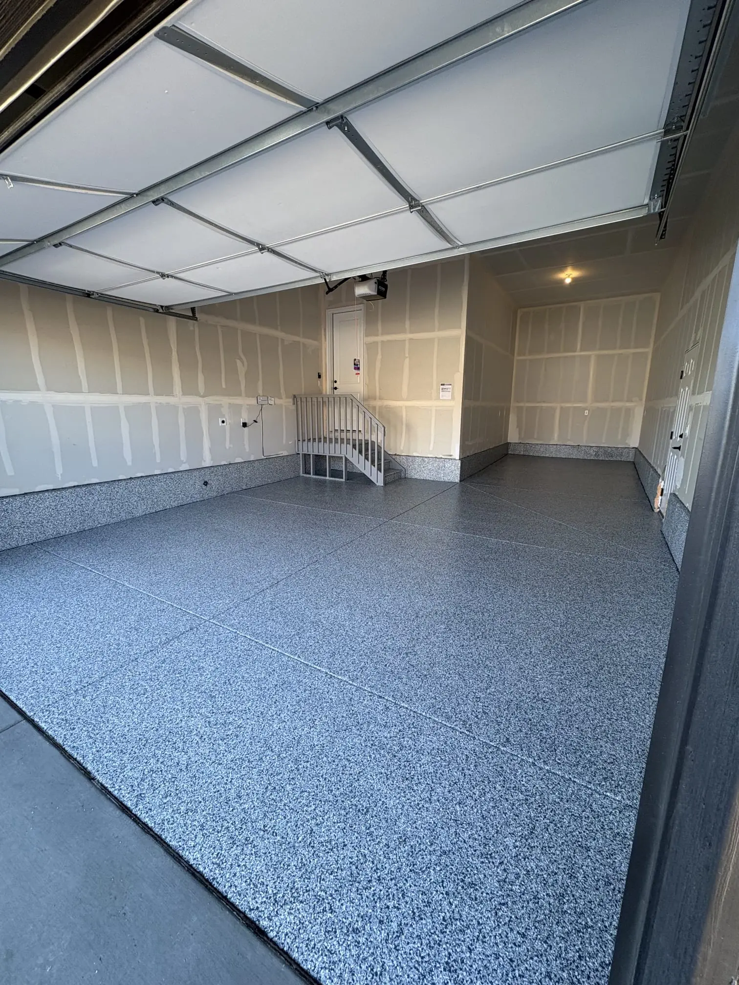 Textured concrete coating on backyard patio with stone pillars, Denver Metro Colorado